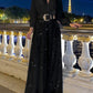 Elegant long-sleeved blouse with V-neckline and wide sequinned jumpsuit trousers